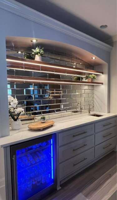 Custom wet bar with mirrored tile backsplash