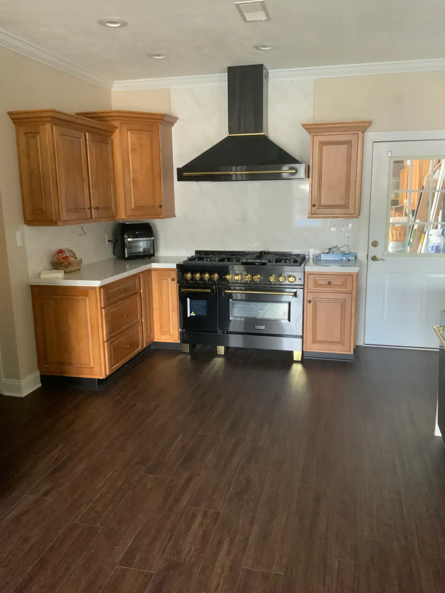 Kitchen with professional range and custom hood